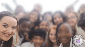 Suzanne, the owner of Magic of Music Ed is pictured in a blurred image of an elementary group of students.