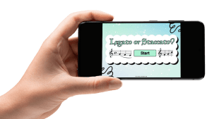 Hand holding a smart phone which displays an articulation active listening game on Boom Learning. In the game 'Legato or Staccato?' music students will listen to 15 classical music excerpts and identify it as 'legato' or 'staccato'. This is an excellent game to build aural skills in music class.