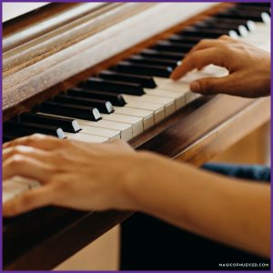 Close-up of an elementary music teacher playing a classroom piano, representing a thoughtful investment as part of managing a general music classroom budget.