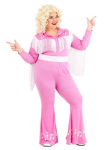 Music teacher dressed in a pink fringe jumpsuit with musical notes and a blonde curly wig, posing in a fun country-music-inspired Halloween costume.
