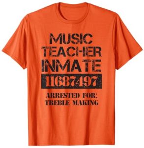 Orange T-shirt with the phrase “Music Teacher Inmate – Arrested for Treble Making” printed in a distressed black font for a funny Halloween costume.
