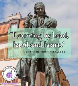 Statue of Johann Heinrich Pestalozzi with quote about learning by head, hand, and heart to illustrate learning in music class.