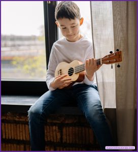 Child playing a ukulele independently, showing focused and self-directed learning in music class